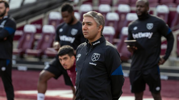 Nick Mohammed as Nate Shelley shows no emotion as he coaches the rival soccer team West Ham United during a practice session in TED LASSO Season 3.