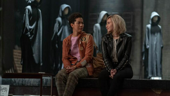 Jasmin Savoy Brown as the survivor Mindy Meeks-Martin and Hayden Panettiere as FBI Agent Kirby Reed sit down together in a hall of Ghostface costumes in New York City from the horror sequel SCREAM VI.