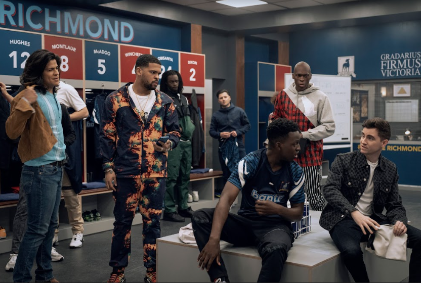 Cristo Fernández, Kola Bokinni, Toheeb Jimoh, and Billy Harris change out of their AFC Richmond soccer team uniforms in the locker room in TED LASSO Season 3 on AppleTV+.