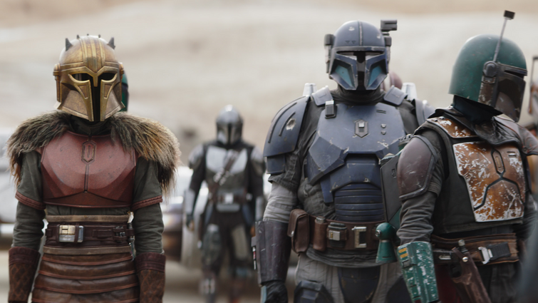 Emily Swallow as The Armorer stands next to Paz Vizsla, Boba Fett, and Din Djarin in their new united Mandalorian clan in Season 3 of the Star Wars series THE MANDALORIAN on Disney+.