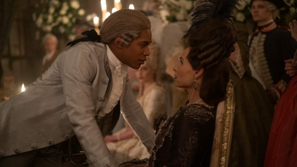Kelvin Harrison Jr. as Joseph Bologne, Chevalier de Saint-Georges, confronts La Guimard played by Minnie Driver face to face while wearing a white wig in the period biopic film CHEVALIER from Searchlight Pictures.