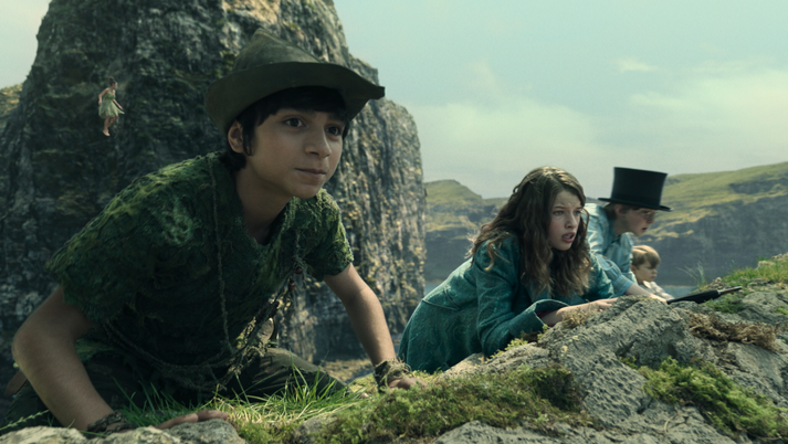 Alexander Molony as Peter Pan and Ever Anderson as Wendy hide together in the live-action version of Neverland in PETER PAN & WENDY now streaming on Disney+.