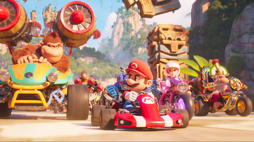 Mario lines up in his signature red go-kart at the starting line next to Donkey Kong, Peach, and Cranky Kong all in their crazy vehicles for a Mario Kart race in THE SUPER MARIO BROS. MOVIE. 