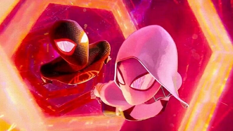 Miles Morales and Spider-Gwen travel through the multiverse in orange and red colored hexagon portals in SPIDER-MAN: ACROSS THE SPIDER-VERSE. 