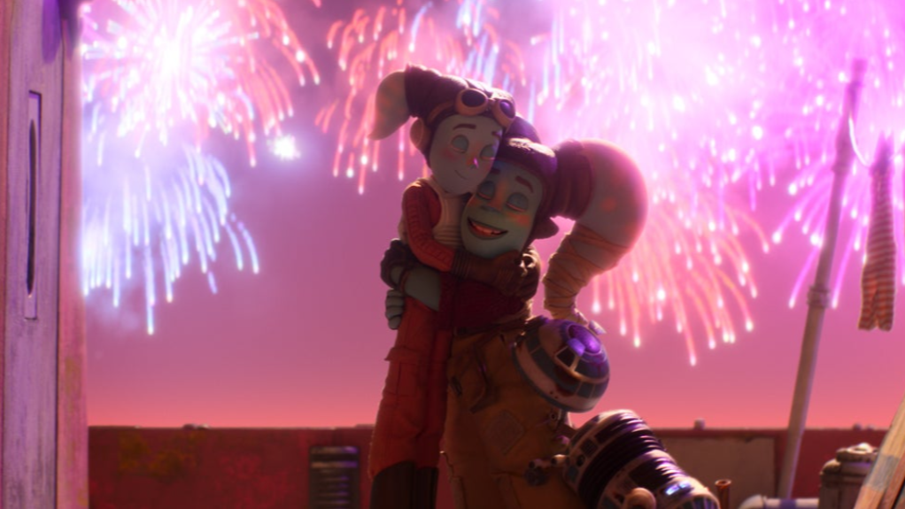 Young Twi'lek pilot Anni and her mother hug each other as the racing duo celebrates their win with fireworks exploding in the sky in the stop-motion short film titled I Am Your Mother from British animation studio Aardman in STAR WARS: VISIONS Volume 2.