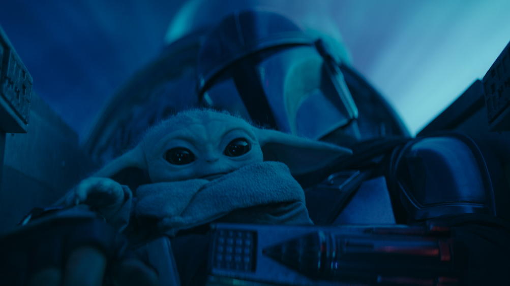 An image of Grogu sitting on the Mandalorian's lap while they fly in hyperspace from the hit Disney+ series for our full list of every Star Wars TV show ranked worst to best. 