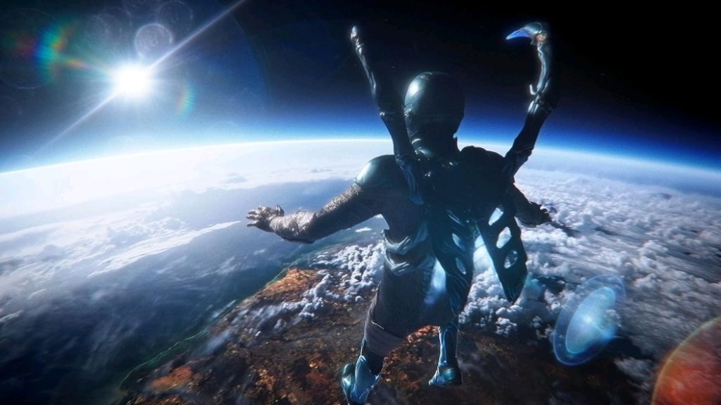 Blue Beetle looks down at the Earth's atmosphere from space during his first flight sequence in the new DC movie BLUE BEETLE.