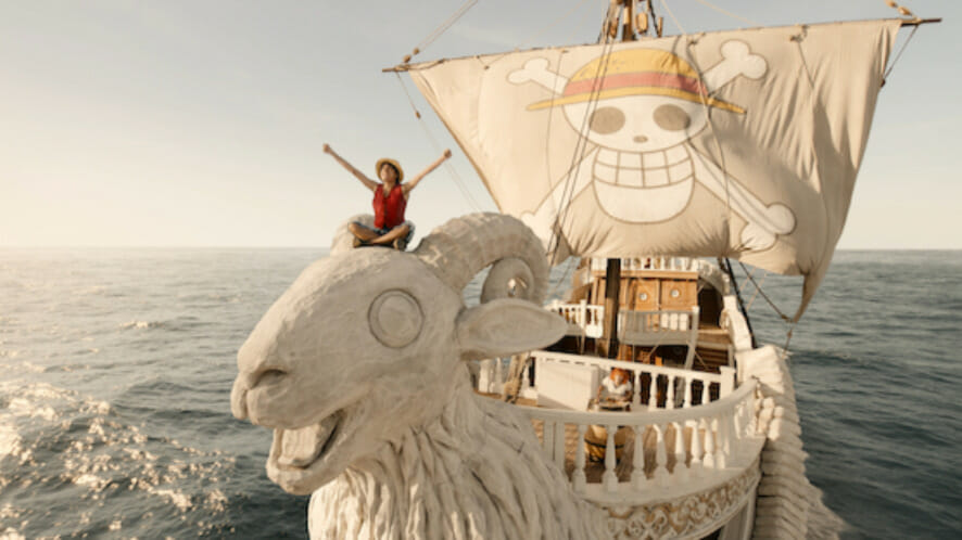 Monkey D. Luffy rides on top of the goat head bow of the Going Merry pirate ship while sailing on the high seas in the live-action ONE PIECE series on Netflix.