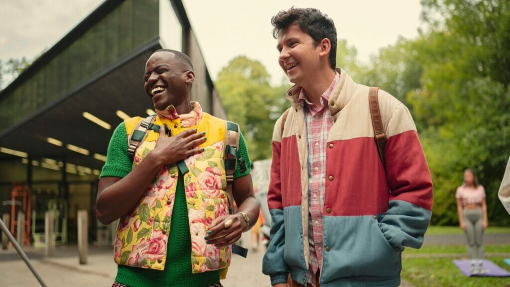 Ncuti Gatwa as Eric and Asa Butterfield as Otis hang out and laugh together in SEX EDUCATION Season 4 on Netflix.