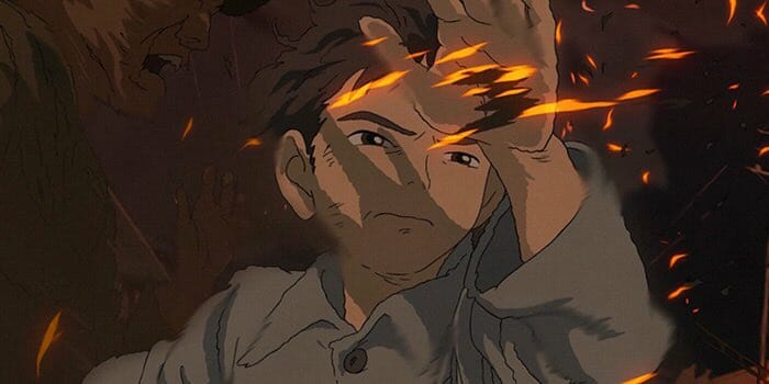 The young boy Mahito makes his way through fire sparks in a chaotic crowd after a bombing in the animated film THE BOY AND THE HERON written and directed by Hayao Miyazaki.