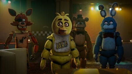 the Foxy, Chica, Freddy Fazbear, and Bonnie animatronics gather together in the rundown lobby of the abandoned Freddy Fazbear's Pizza in Blumhouse's FIVE NIGHTS AT FREDDY'S movie.