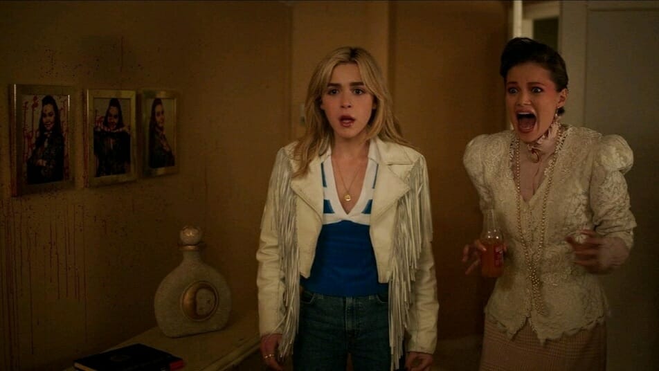 Kiernan Shipka and Olivia Holt stumble upon a bloody murder in total shock while wearing quirky '80s outfits in the horror comedy TOTALLY KILLER on Amazon Prime Video.