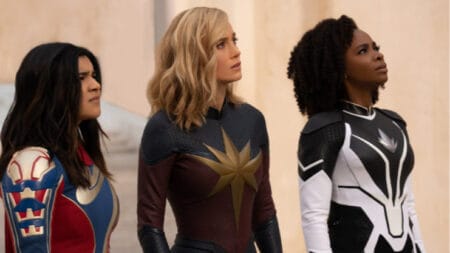 Iman Vellani, Brie Larson, and Teyonah Parris wear their new superhero costumes as Ms. Marvel, Captain Marvel, and Photon respectively in the MCU movie THE MARVELS.