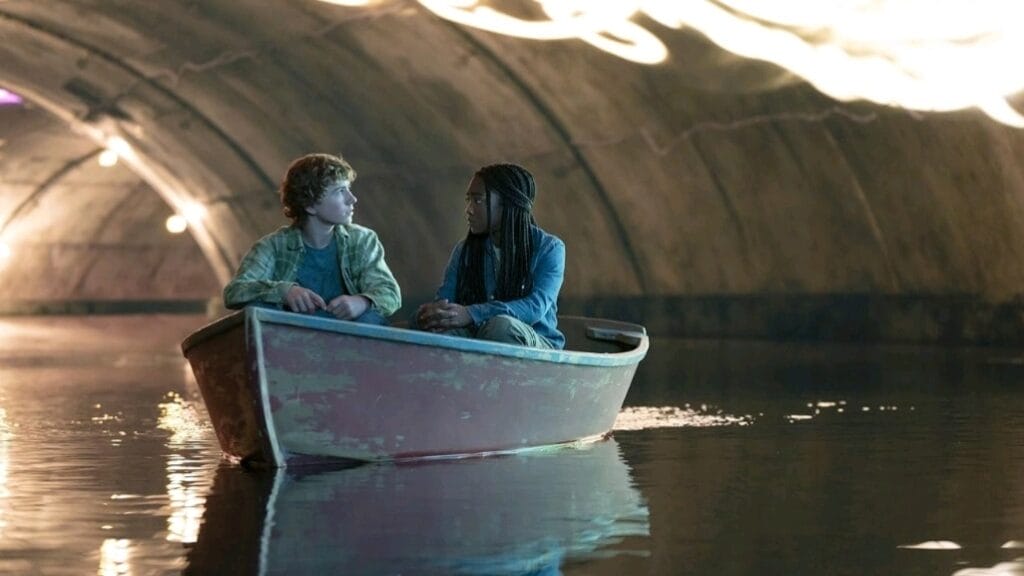 Walker Scobell and Leah Sava Jeffries star as Percy Jackson and Annabeth Chase riding a boat together in the PERCY JACKSON AND THE OLYMPIANS Disney+ series. 