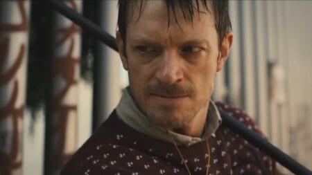Joel Kinnaman stars as the silent vigilante Brian Godluck as he prepares to swing a crowbar in an intense close-up shot from the action movie SILENT NIGHT.