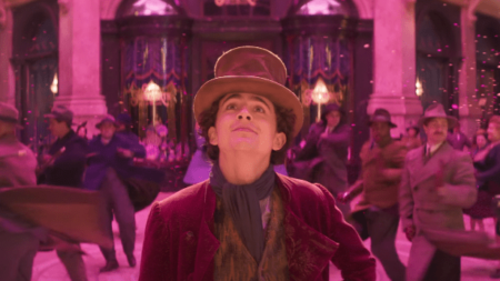 Timothee Chalamet stars as Willy Wonka in the middle of spectacular musical number set in the gallery gourmet in London in the movie musical WONKA.