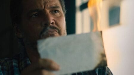 ‘Freaky Tales’ Review – A New Career High for Ryan Fleck and Anna Boden | Sundance 2024 Pedro Pascal stars as hit man Curtis holding a burning letter in a dinner in the movie FREAKY TALES.