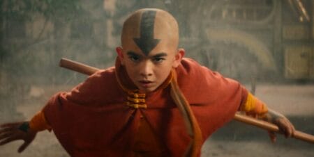 Aang played by Gordon Cormier strikes an epic battle pose holding his signature airbender staff while wearing his classic costume from the animated show in the live-action AVATAR: THE LAST AIRBENDER series on Netflix.