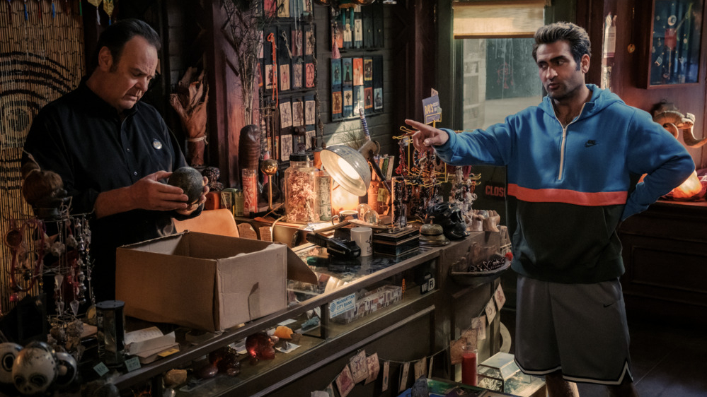 Kumail Nanjiani stars as Nadeem Razmaadi searching through a room of artifacts with Ray Stantz played by Dan Aykroyd in GHOSTBUSTERS: FROZEN EMPIRE. 
