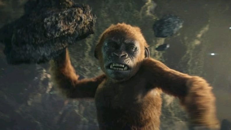 The mini kong Suko throws his arm back as he's getting ready to throw a giant boulder at an enemy in the Monsterverse sequel GODZILLA X KONG: THE NEW EMPIRE. 