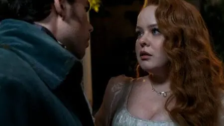 Nicola Coughlan and Luke Newton share an intimate moment as Penelope Featherington and Colin Bridgerton in BRIDGERTON Season 3 Part 1 now streaming on Netflix.