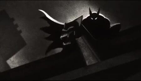 New Arrivals for Prime Video and Freevee August 2024 A black-and-white silhouette of Batman perched on top of a gargoyle in the 1940s themed animated series BATMAN: CAPED CRUSADER now streaming on Amazon Prime Video in August 2024.