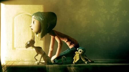 Henry Selick and Teri Hatcher on the Enduring Legacy of ‘Coraline’ 15 Years Later – Exclusive Interview The iconic image of Coraline and her thin black cat crawling through a small hidden door with golden light shinning from the other side in the 2009 animated film written and directed by Henry Selick.