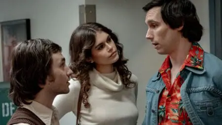 Gabriel LaBelle as Lorne Michaels, Kaia Gerber as Jacqueline Carlin, and Cory Michael Smith as Chevy Chase have a tense confrontation in the NBC studio dressing rooms in the biographical film SATURDAY NIGHT.