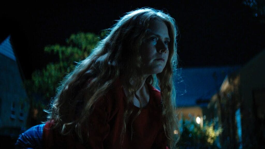 Amy Adams crawls on all floors in her front yard like a dog in the absurd dark comedy NIGHTBITCH.