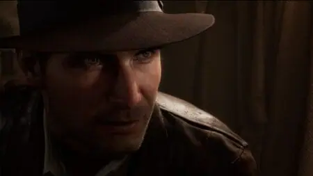 ‘Indiana Jones and the Great Circle’ Review – An Inspired Take on a Classic Indy Adventure A close up of Indiana Jones, now voiced by Troy Baker, in his iconic brown fedora in the video game INDIANA JONES AND THE GREAT CIRCLE.