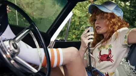 ‘Poker Face’ Season 2 Review – A Stronger and Even Stranger Murder Mystery Road Trip Natasha Lyonne stars as former cocktail waitress Charlie Cale laying back in a muscle car with her legs up on the steering wheel as she speaks into a handheld radio microphone in POKER FACE Season 2 streaming only on Peacock.