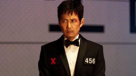 ‘Squid Game’ Season 3 Review – A Painfully Safe, Yet Still Enjoyable Conclusion Lee Jung-jae stars as Seong Gi-hun, aka Player 456, sitting down in a black tuxedo for his final meal in the penultimate episode of SQUID GAME Season 3.