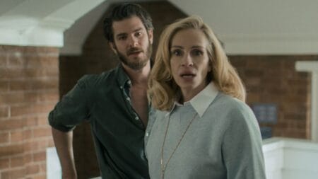 ‘After the Hunt’ Review – Julia Roberts Carries a Messy Allegation Psychodrama | Venice 2025 Julia Roberts looks towards the camera shocked while Andrew Garfield stands right behind her with a look of disappointment on his face in the psychological thriller AFTER THE HUNT.