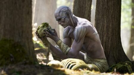 New Arrivals for Netflix November 2025 Jacob Elordi stars as the Creature showing off all of his body stitches while holding up a human skull covered in green moss in the middle of a forest in Guillermo del Toro's FRANKENSTEIN, which is included in the Netflix November 2025 list of new movies and TV shows.