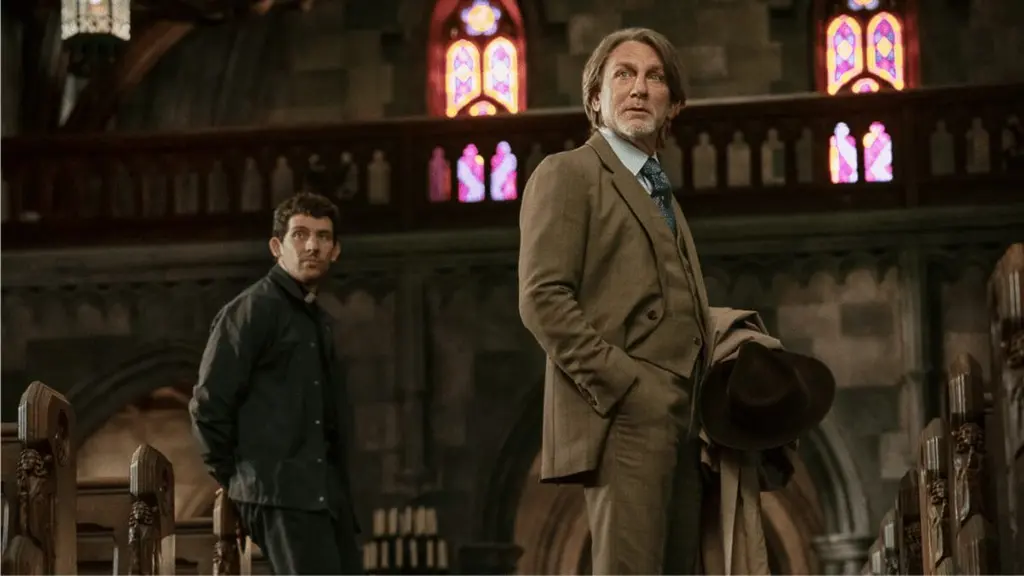 Daniel Craig stars as private detective Benoit Blanc meeting the kind young priest Jud Duplenticy, played by Josh O'Connor, inside an old Gothic church in WAKE UP DEAD MAN: A KNIVES OUT MYSTERY, which is included in the Netflix December 2025 list of new movies and TV shows.