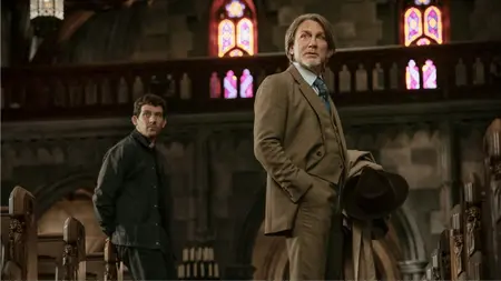 Daniel Craig stars as private detective Benoit Blanc meeting the kind young priest Jud Duplenticy, played by Josh O'Connor, inside an old Gothic church in WAKE UP DEAD MAN: A KNIVES OUT MYSTERY, which is included in the Netflix December 2025 list of new movies and TV shows.