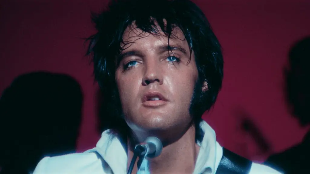‘EPiC: Elvis Presley in Concert’ is a Bold Cinematic Experience Worthy of the King A close-up shot of Elvis Presley looking tired and sweaty during a live performance on stage while wearing his iconic white leather jacket in the music documentary EPiC: ELVIS PRESLEY IN CONCERT.