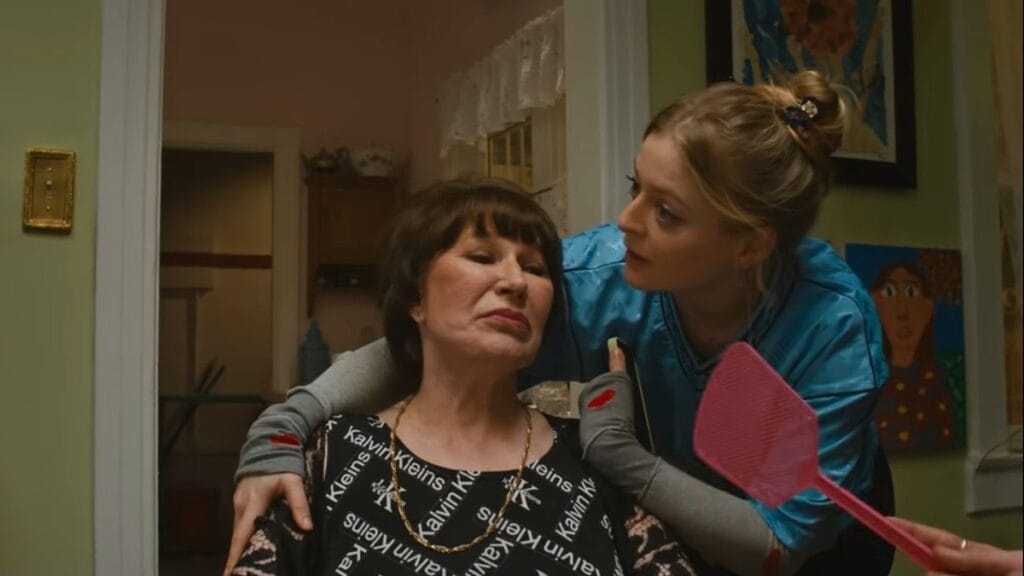 Anna Baryshnikov comforts her Russian babushka played by Galina Jovovich at their small dinner table inside their cramped West Hollywood apartment in the movie IDIOTKA.