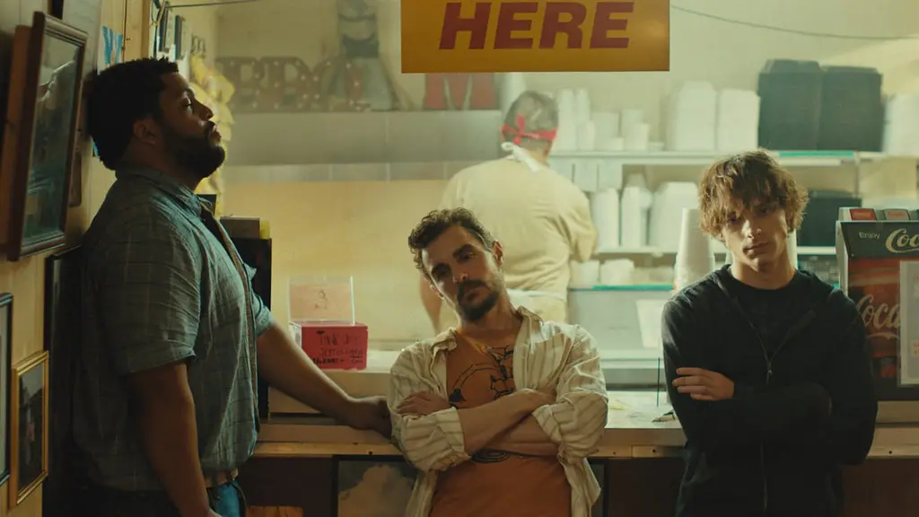 O'Shea Jackson Jr., Dave Franco, and Mason Thames all look mad and exhausted as they wait together for their order at a rundown diner in the raunchy buddy comedy IDIOTS.