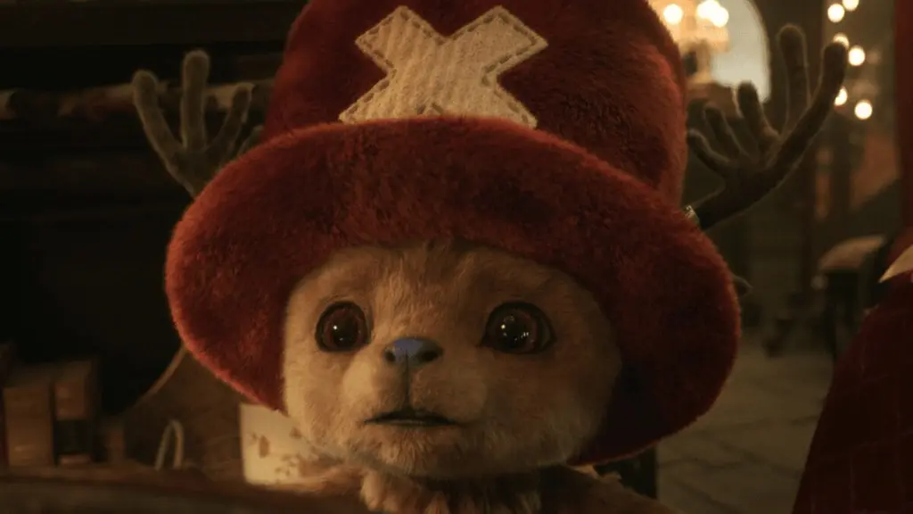A close-up shot of the small reindeer doctor Tony Tony Chopper making his live-action debut while wearing his iconic fuzzy red top hat in ONE PIECE Season 2 on Netflix.