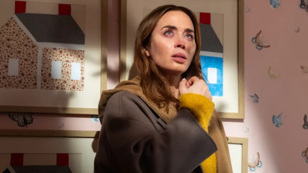 Emily Blunt stars as meteorologist Margaret Fairchild looking up at mysterious bright lights in total shock from inside a children's bedroom in DISCLOSURE DAY.