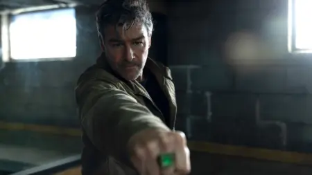 ‘Lanterns’ Review – The DCU’s Brightest Day Hal Jordan raises his fist with the Green Lantern ring towards the camera in HBO's LANTERNS show.