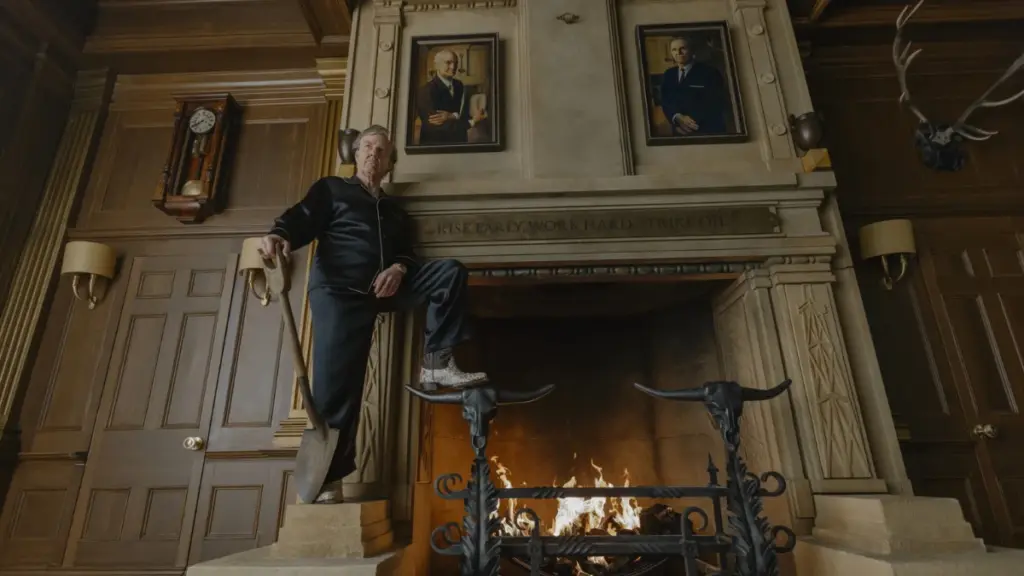Tom Cruise stars as ultra wealthy oil tycoon Digger Rockwell posing with his shovel in his giant mansion in Alejandro G. Iñárritu's satirical black comedy film DIGGER.