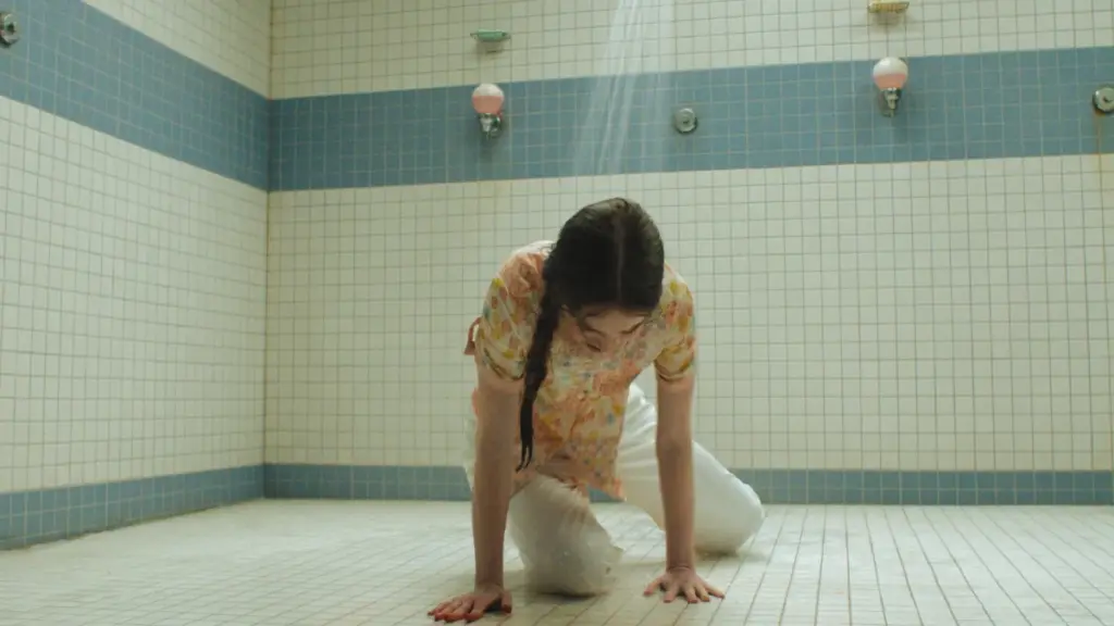 Summer H. Howell stars as awkward teenager Carrie White crying on the floor of her high school gym showers in the CARRIE series on Prime Video. 
