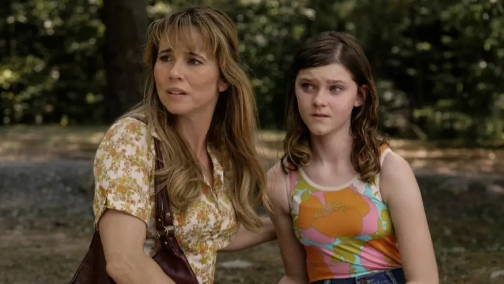 Linda Cardellini stars as Pamela Voorhees and Gwendolyn Sundstrom as the young girl Grace in the CRYSTAL LAKE prequel series on Peacock. 