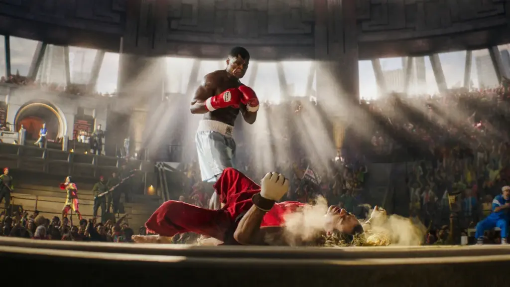 Balrog played by 50 Cent knocks down Ken played by Noah Centineo in a large fighting arena in the live-action STREET FIGHTER movie.