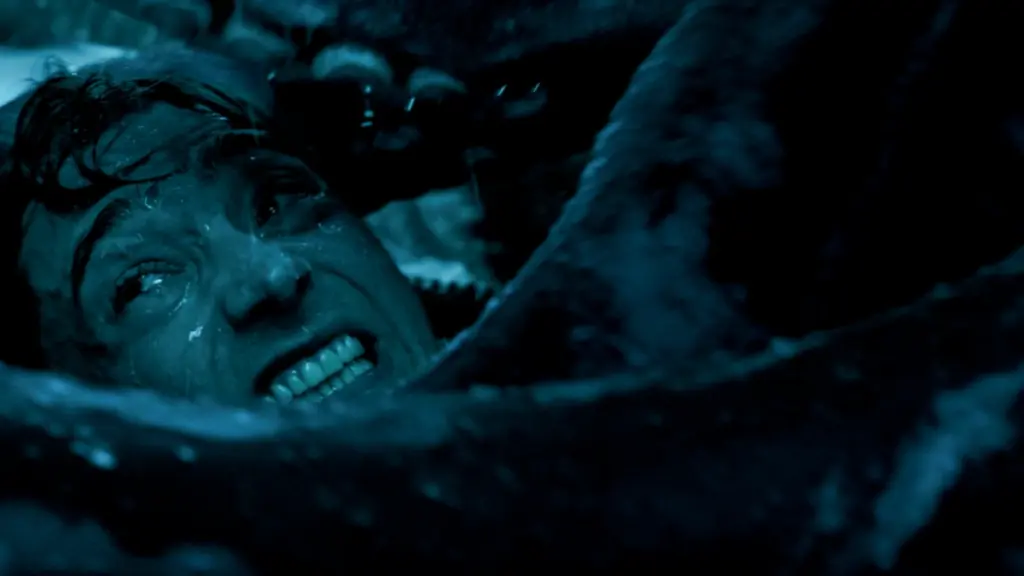 A claustrophobic close-up shot of Austin Abrams getting attacked by a giant squid while inside the stomach of a sperm whale in the epic survival thriller WHALEFALL.